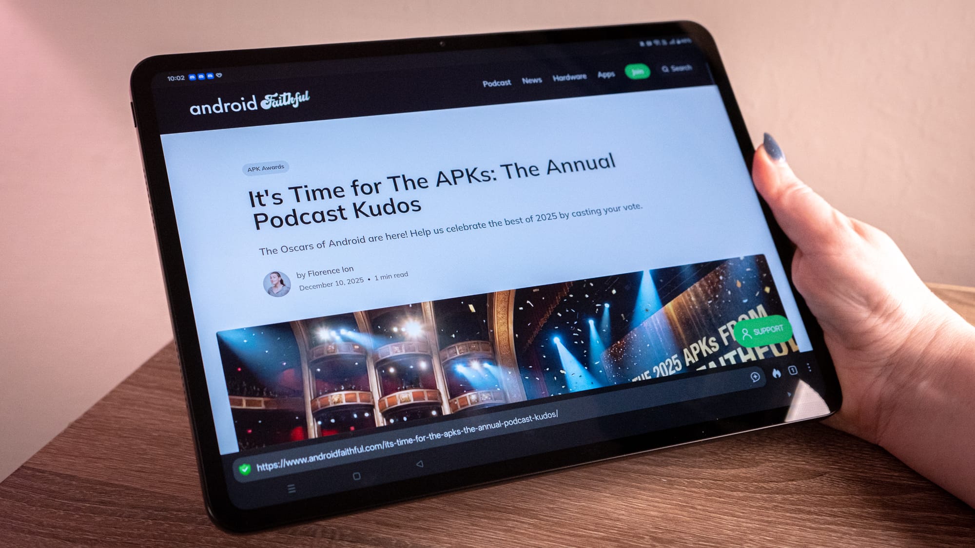 a photo of a person holding a tablet with the APKs on