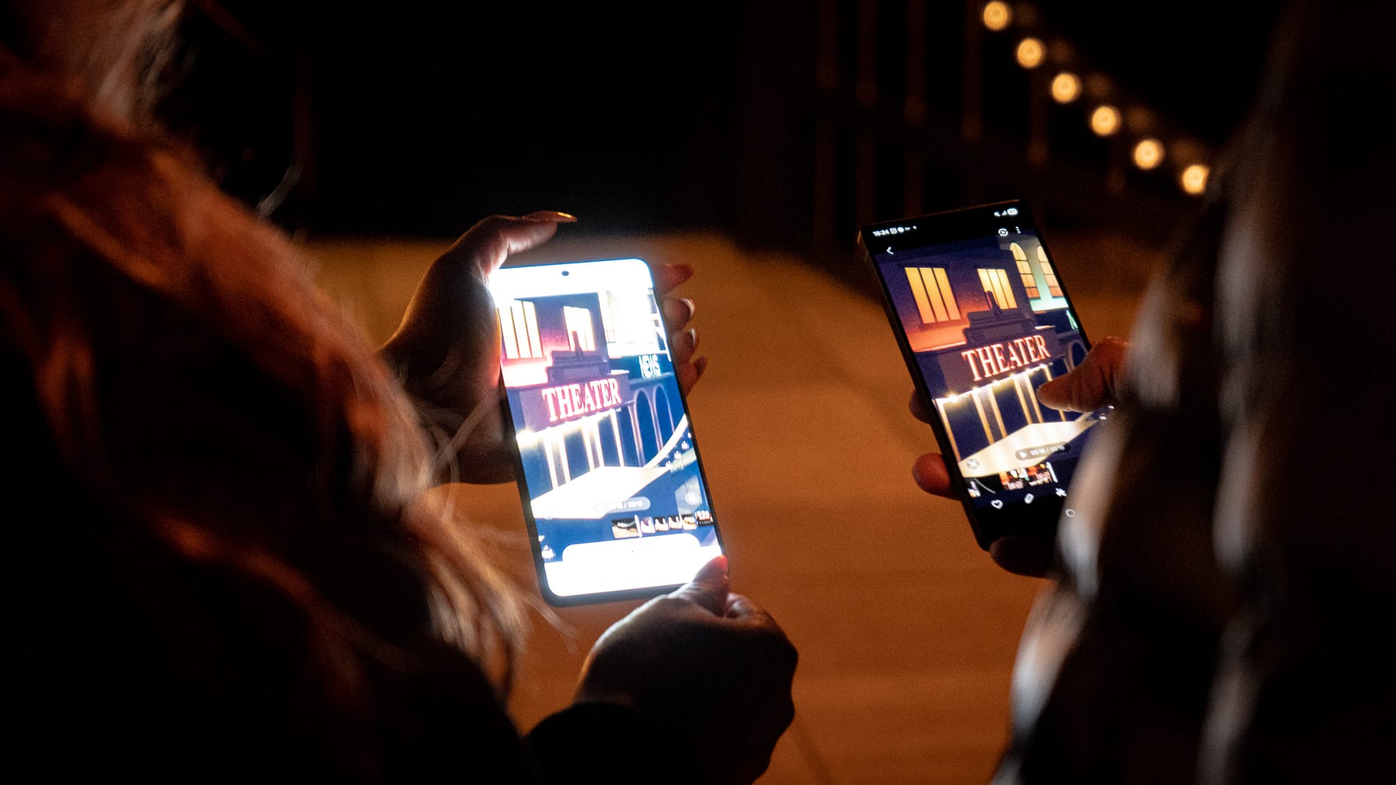 a photo of two people holding up two phones side by side to compare results 