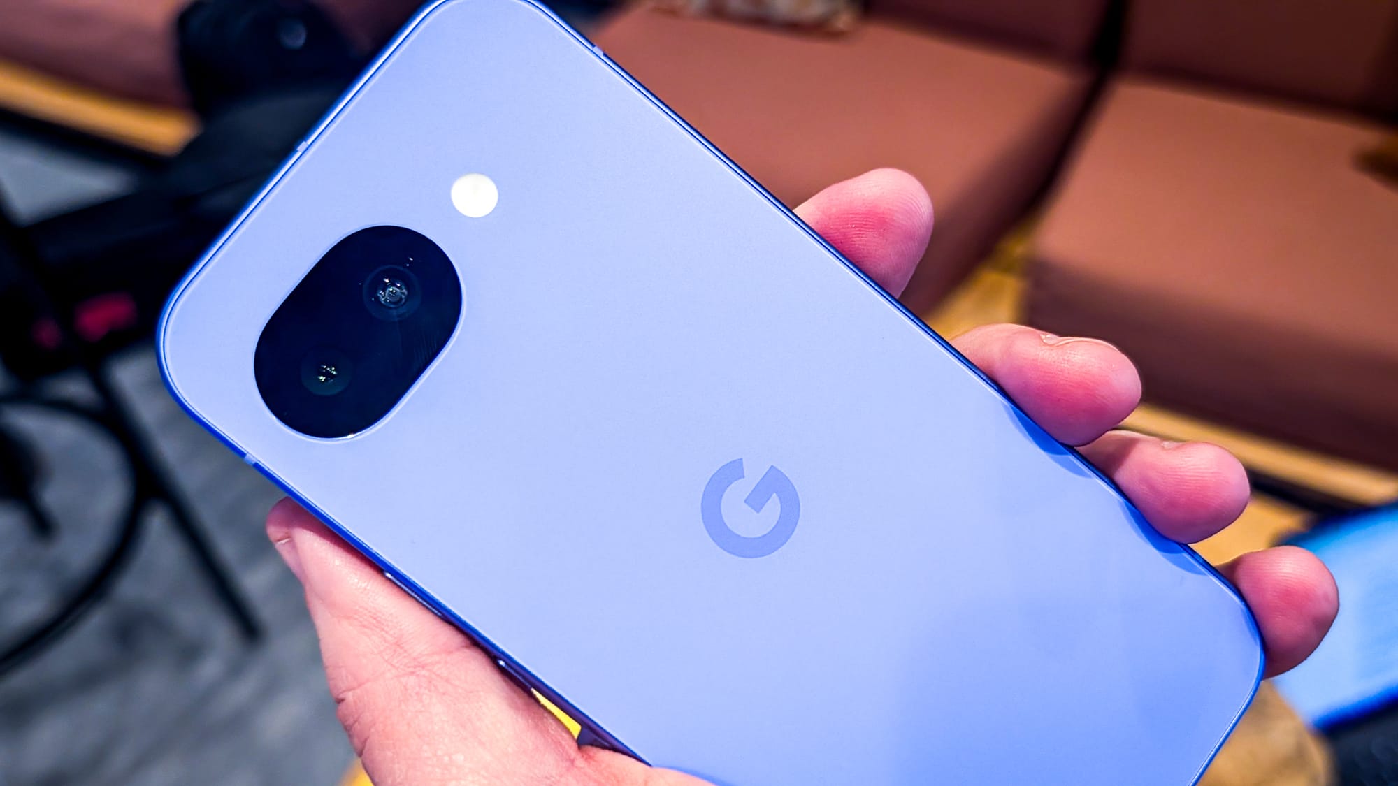 A photo of a person holding the Pixel 10a, closer to the camera