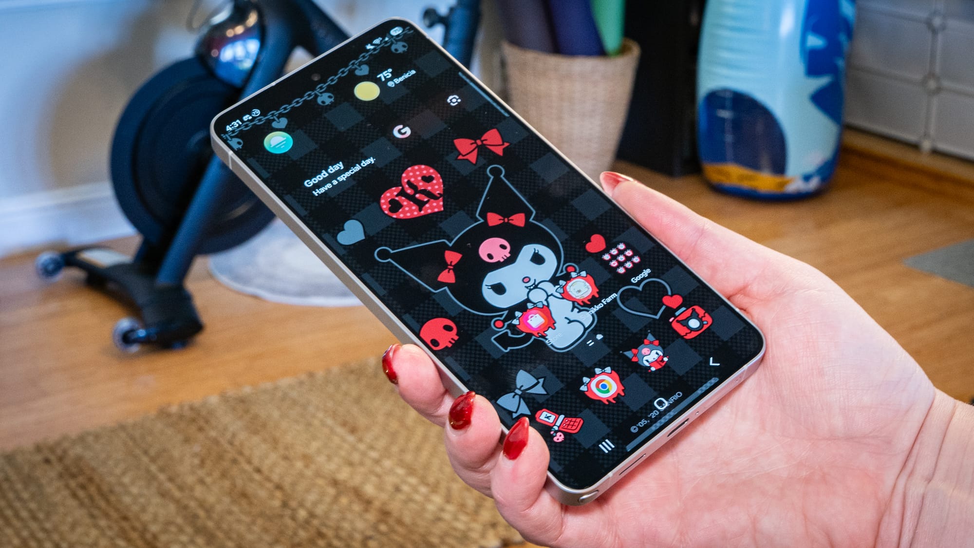 a photo of a person holding the Galaxy s26 Ultra in a living room