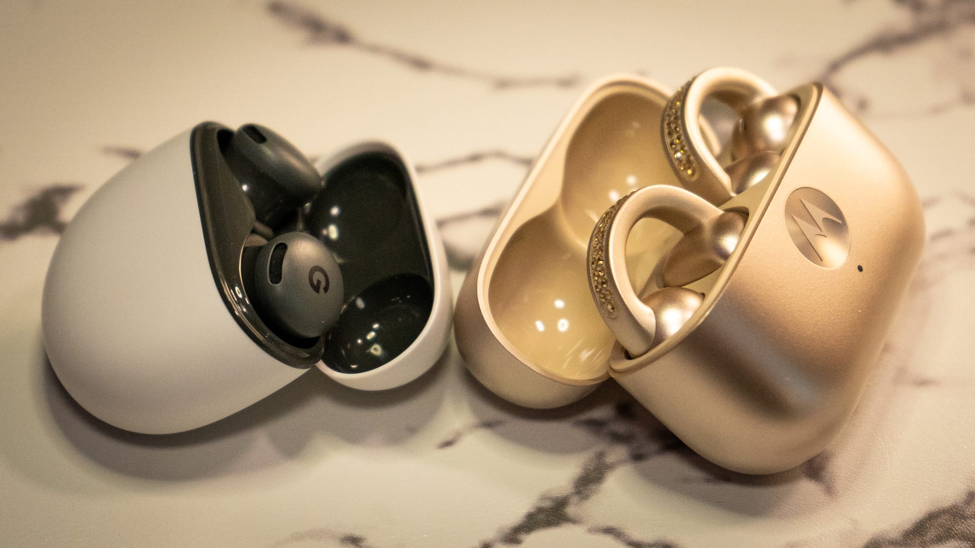 A photo of the Pixel Buds 2a and the Moto Bud Loops