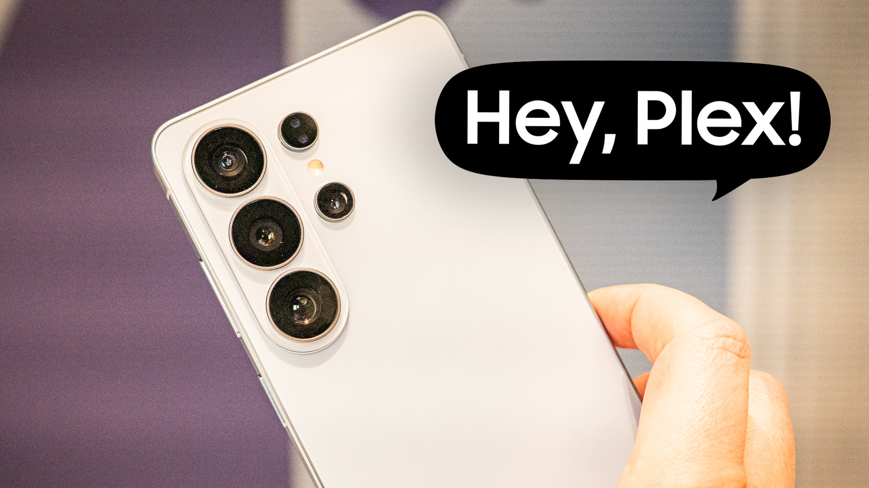 A photo of someone holding the Galaxy s26 Ultra with a speech bubble that says "hey plex!" 